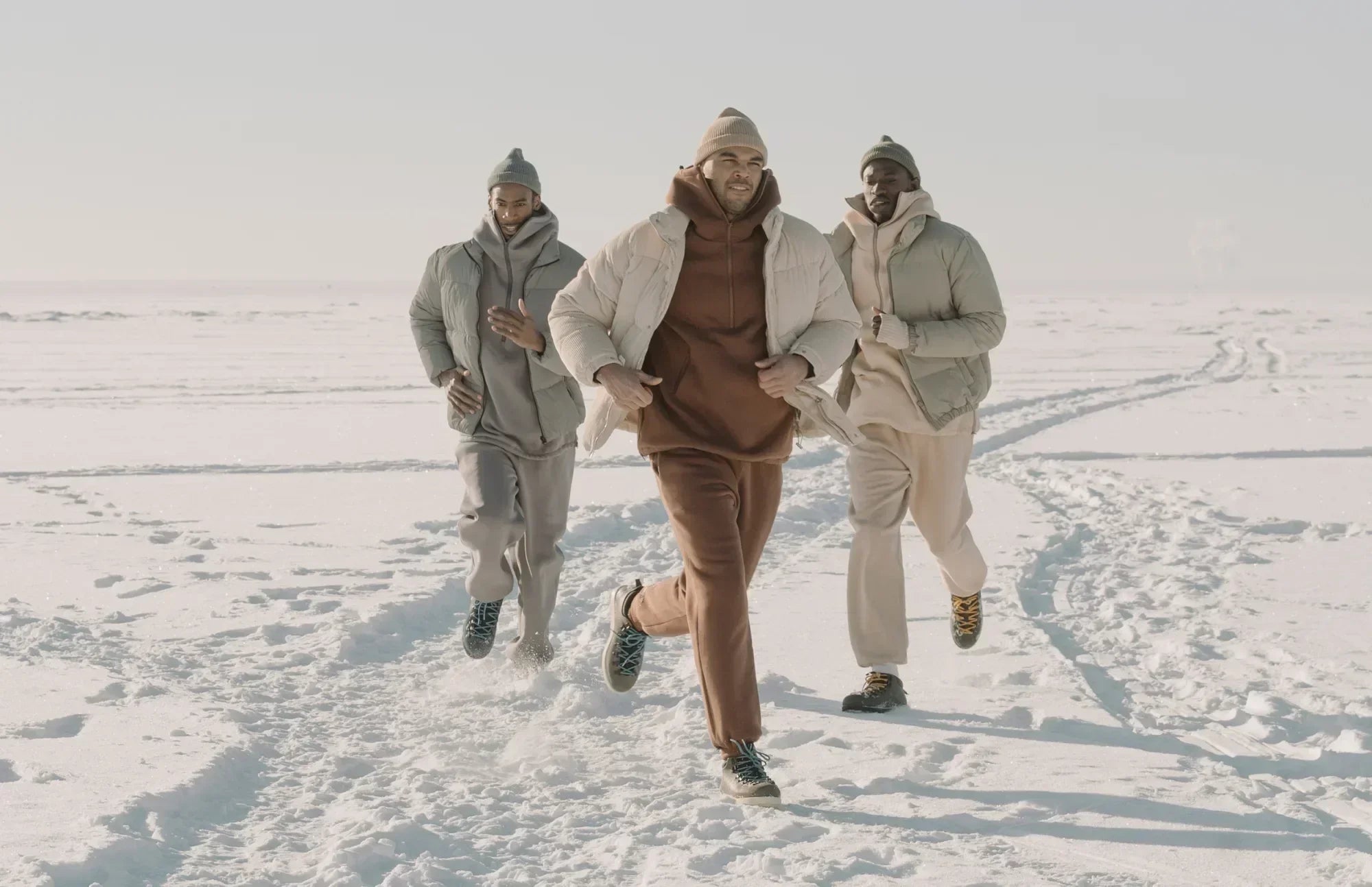 Three men running in winter gear, representing strength, energy, and the benefits of probiotics for men’s health