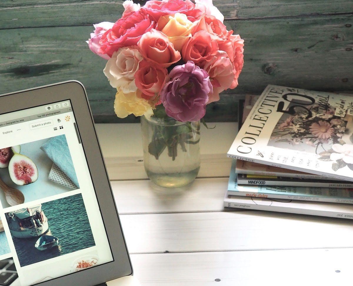 laptop-flower-bouquet-and-magazines-on-white-table