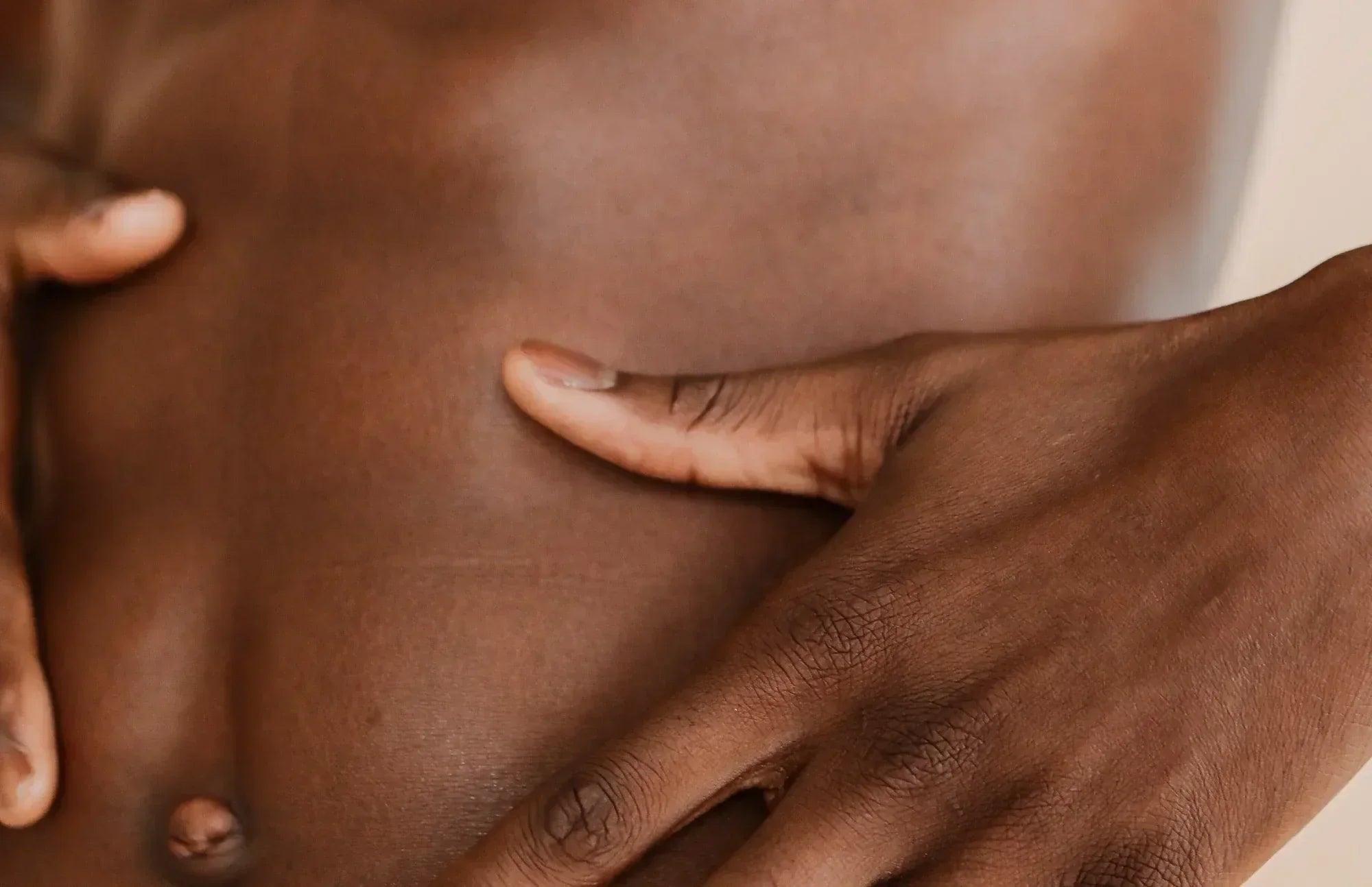 Person touching their stomach, highlighting digestive discomfort and the benefits of probiotics for gas and bloating relief