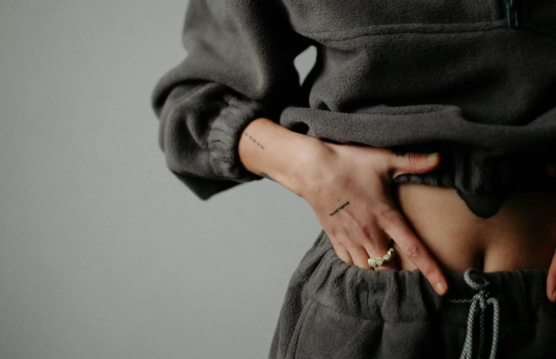 Person holding their stomach, illustrating digestive discomfort or gut health concerns